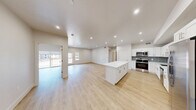 This contemporary 1,080 square foot condo in Saint George, UT offers a harmonious blend of style and functionality. The open-concept layout seamlessly integrates the kitchen, living, and dining areas, creating an airy and inviting atmosphere. The kitchen is a highlight, featuring crisp white cabinetry, stainless steel appliances, and a striking gray tile backsplash. A large center island with a pristine white countertop provides additional prep space and casual seating.

The two bedrooms are generously sized, with the primary bedroom boasting 180 square feet of space. Each of the three bathrooms showcases modern fixtures and finishes, including vanities with ample storage. The unit is equipped with two closets, ensuring plenty of storage options.

Throughout the condo, light wood-look flooring adds warmth and complements the neutral color palette. Recessed lighting and sleek ceiling fans enhance the modern aesthetic while providing optimal illumination and air circulation. A standout feature is the balcony, accessible through sliding glass doors, offering a private outdoor space and city views.

The condo's design prioritizes natural light, with large windows in the bedrooms and living areas. This single-story unit combines comfort and style, making it an ideal urban retreat in the heart of Saint George.