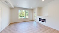Located at 8003 NE 13th Ave in Vancouver, WA, this thoughtfully designed 2-bedroom, 2-bathroom apartment offers a clean, modern aesthetic throughout its single-floor layout. Light-toned hardwood flooring flows seamlessly through every room, creating a cohesive and airy feel.

The open-concept kitchen and living area serves as the heart of the unit. The kitchen is well-appointed with light wood upper cabinetry, dark lower cabinets, a white subway tile backsplash, stainless steel appliances, and a central island with a crisp white countertop — ideal for both cooking and entertaining. The adjoining living room features recessed lighting, a sleek wall-mounted electric fireplace, and large sliding glass doors that open to a private balcony overlooking mature trees and green surroundings.

Both bedrooms are comfortably sized, bathed in natural light through generously sized windows with pleasant outdoor views. The primary bedroom includes a closet and a wall-mounted mini-split HVAC unit for personalized climate control. The second bedroom is bright and versatile. Each of the two full bathrooms is finished with clean, neutral tiling and includes a soaking tub and shower combination with brushed nickel fixtures. A connecting hallway ties all rooms together efficiently, completing this well-organized and modern living space.
