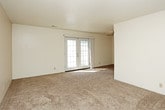 This single-floor residence offers a practical and comfortable layout across several well-defined living spaces. The kitchen is equipped with warm wood-toned cabinetry, light-colored countertops, and tile flooring. It includes a double-basin sink, an electric range with overhead microwave, a dishwasher, and a refrigerator, providing ample functionality for everyday cooking. The L-shaped configuration maximizes counter and storage space efficiently.

The living area is generously proportioned, featuring plush wall-to-wall carpeting, a ceiling fan, and a textured ceiling. A glass-paneled door allows natural light to flow in and provides access to the exterior. The open layout connects seamlessly to adjacent spaces, creating a cohesive flow throughout the home.

The bedrooms are carpeted and well-lit, each featuring windows with views of mature outdoor trees, giving the rooms a calm, natural ambiance. The textured ceilings and neutral wall tones create a clean, understated aesthetic throughout.

The bathroom is finished with tile flooring, a full tub-and-shower combination with white tile surround, a vanity with light countertop, and chrome fixtures. A dedicated walk-in closet, finished with carpet and a full-width hanging rod, provides substantial storage. Overall, the space is clean, functional, and move-in ready.