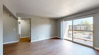 Located at 1919 N 76th Dr in Kansas City, KS, this one-bedroom, one-bathroom unit offers a well-organized and functional layout across a single floor. The open living room is a welcoming space featuring wood-style flooring, neutral gray walls, and large sliding glass doors that lead to a private balcony, flooding the room with natural light and providing pleasant outdoor views. The living area flows seamlessly into the galley-style kitchen, which is equipped with rich, warm-toned wood cabinetry, granite-look countertops, a tile backsplash, stainless steel appliances including a gas range and refrigerator, and a built-in sink. The bedroom is a comfortable retreat with its own ceiling fan, a window that brings in natural light, and direct access to two closets, offering generous storage. The bathroom features a full soaking tub with tile surround, providing a clean and functional space. Wood-style flooring is consistent throughout the unit, contributing to a cohesive and modern aesthetic. The textured ceilings and neutral color palette create a calm, move-in-ready atmosphere suitable for a variety of living styles.