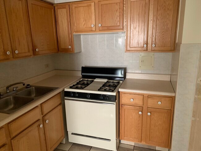 ceramic tiled Kitchen with oak cabinets - 2000 W Summerdale Ave