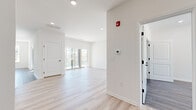 Located at 688 Pennsylvania Ave in Elizabeth, NJ, this thoughtfully designed one-bedroom, two-bathroom residence offers a generous and well-appointed single-floor layout. The open-concept living and kitchen area is bright and welcoming, featuring light-toned hardwood flooring, crisp white walls, and recessed lighting throughout. Large sliding glass doors in the living area lead to a private balcony, flooding the space with natural light and providing views of the surrounding neighborhood.

The kitchen is a standout feature, outfitted with rich, dark-toned shaker cabinetry accented by matte black hardware, quartz countertops, a subway tile backsplash, and a full suite of stainless steel appliances including a gas range, over-the-range microwave, refrigerator with ice maker, and dishwasher. Pendant lighting over the peninsula adds a stylish, modern touch.

The spacious primary bedroom offers a serene retreat with neutral tones, wood-look flooring, and a closet with built-in shelving. Both bathrooms are elegantly finished, with one featuring marble-look tile, a glass-enclosed tub and shower, a wood vanity with quartz countertop, and black fixtures. Two hallways connect the spaces seamlessly, contributing to an efficient and functional floor plan throughout.