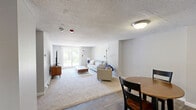 Located at 14 Tri City Rd in Somersworth, NH, this single-floor residence offers a well-organized layout featuring two bedrooms, one bathroom, a combined kitchen and dining area, and a comfortable living room. The living room is bright and inviting, featuring sliding glass doors that flood the space with natural light and provide views of the surrounding greenery. Plush carpeting and baseboard heating add warmth and comfort throughout the living areas.

The kitchen is well-appointed with warm wood cabinetry, ample counter space with laminate countertops, and white appliances including an electric stove and refrigerator. Durable hardwood-style flooring extends through the kitchen and into the adjacent dining area, which offers an intimate setting with a textured ceiling.

The spacious primary bedroom features a large window with natural light, carpeted flooring, and baseboard heating, while the second bedroom includes a built-in closet and recessed lighting. Both rooms maintain a clean, neutral palette.

The full bathroom is finished with tile flooring and includes a shower-tub combination. A dedicated hallway and closet provide practical storage solutions. Overall, this residence delivers a functional and comfortable living environment suited for everyday living.
