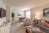 Located at 3401 Montgomery Dr in Mays Landing, NJ, this two-story residence offers a thoughtfully designed layout spread across two well-organized floors. The main level centers around an open-concept living and dining area finished with plush carpeting and neutral walls that create a bright, welcoming atmosphere. The living room provides generous space for seating and is accented by framed artwork, while the adjacent dining area features a pendant light fixture and a large window that invites natural light and outdoor views. A tiled entryway with a staircase leads between floors, and a secondary living or flex space on the lower level offers additional room for relaxation or entertainment.

The kitchen is equipped with warm-toned wooden cabinetry, stainless steel appliances including a gas range, microwave, dishwasher, and refrigerator, and tile flooring that complements the cabinetry tones. Bathrooms throughout the home feature tile flooring, single-sink vanities with wooden cabinetry, and shower-tub combinations. The bedrooms are carpeted and bathed in soft, neutral tones, each offering closet storage. The upper level includes a spacious primary bedroom with multiple closets. Overall, the home maintains a clean, understated aesthetic throughout.