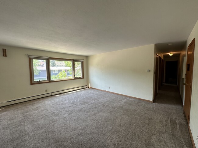 Large living room open to dining room. - The Virginian Apartments