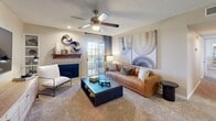 Located in Albuquerque, NM, this single-floor, 2-bedroom, 2-bathroom residence offers a well-organized and functional layout. The open-concept kitchen is equipped with stainless steel appliances — including a refrigerator, range, and microwave — warm wood cabinetry, light countertops, and a peninsula that connects seamlessly to the dining area, making it ideal for everyday living and entertaining. The living room features plush carpet, a cozy fireplace with a wood mantel, built-in shelving, a ceiling fan, and a sliding glass door that brings in natural light. Both bedrooms are carpeted and comfortably sized, with the primary bedroom offering ample closet space. Each bathroom includes a tub-shower combination with clean tile surround and safety grab bars. A dedicated laundry area houses a full-size washer and dryer with overhead shelving for added storage. Textured ceilings and neutral tones carry throughout the space, creating a cohesive and calm ambiance. The unit also includes a closet for additional storage needs. This residence combines practical amenities with a comfortable layout suited for a range of lifestyles.