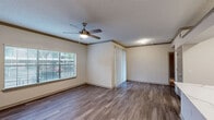 Located at 3700 Preston Rd in Plano, Texas, this one-bedroom, two-bathroom residence offers a well-organized single-floor layout designed for comfortable everyday living. The open living area features durable hardwood-style flooring, crown molding, a textured ceiling, and a ceiling fan with integrated lighting. Large windows fitted with blinds allow ample natural light to fill the space, creating a bright and welcoming atmosphere.

The kitchen is designed for both function and style, featuring white cabinetry, light stone countertops, a peninsula with a built-in sink, and a full suite of stainless steel appliances including a refrigerator, gas range, and microwave. Hardwood-style flooring continues throughout, lending a cohesive look to the common areas.

The bedroom is carpeted for comfort and includes a ceiling fan, a window with outdoor views, a spacious walk-in closet with built-in shelving, and direct access to a private en-suite bathroom. The bathrooms are finished with white cabinetry, light countertops, hardwood-style flooring, and a tiled shower-tub combination with brushed nickel fixtures and accents. A dedicated closet provides additional storage. The overall aesthetic is clean, neutral, and move-in ready.
