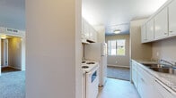 Located in Arden-Arcade, California, this two-bedroom, one-bathroom unit offers a practical and well-organized single-floor layout. The combined living and dining area forms the heart of the home, providing an open, flexible space bathed in natural light from a large window with views of the surrounding neighborhood. The kitchen is efficiently arranged with white cabinetry, granite-style countertops, and white appliances including a range and refrigerator, with tile flooring that transitions smoothly into the carpeted living area. Both bedrooms are generously proportioned, featuring soft carpeting, neutral wall tones, and windows that bring in natural light and outdoor views. The primary bedroom is notably spacious and includes access to closet space. A full bathroom features a tiled tub-shower combination, tile flooring, and clean white fixtures. Storage is a standout feature of this unit, with four closets distributed throughout, including a walk-in closet fitted with built-in shelving and hanging rods. A private balcony extends the living space outdoors. A dedicated hallway connects the rooms cohesively, completing the functional and comfortable layout of this Arden-Arcade residence.