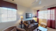 Located at 100 Glenwood Dr in Heath, Ohio, this single-floor residence offers a well-organized and functional layout across a comfortable footprint. The living room serves as the heart of the home, featuring plush carpeting, multiple windows with blinds that allow abundant natural light, and a ceiling fan overhead. The space accommodates a variety of seating arrangements and provides a warm, welcoming atmosphere.

Adjacent to the living area, the dining room includes a pendant chandelier above a central dining table, a window for additional natural light, and carpeted flooring that flows seamlessly throughout the common areas. The galley-style kitchen is outfitted with warm oak cabinetry, ample counter space, a double-basin sink, and white appliances including a range, refrigerator, and microwave. Tile flooring in the kitchen provides a practical and easy-to-maintain surface.

The residence includes two bedrooms, each carpeted and filled with natural light from windows with blinds. One bedroom features a closet accessible through a wood-panel door. The bathroom offers tile flooring, a vanity with wood cabinetry, and a separate water closet area, providing a clean and practical layout. Overall, this home presents a straightforward, comfortable design well-suited for everyday living.