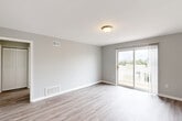 Located at 137 Princeton Ave in Claymont, Delaware, this single-floor, 2-bedroom, 2-bathroom home offers a clean, modern aesthetic throughout. The living room is bright and welcoming, featuring light hardwood-style flooring, neutral gray walls, and a sliding glass door that opens to an outdoor balcony, filling the space with natural light and providing pleasant outdoor views. The kitchen is well-equipped with white shaker-style cabinetry, light countertops, and a full suite of stainless steel appliances including a refrigerator, electric range, built-in microwave, and dishwasher, all complemented by hardwood-style flooring and a natural light-admitting window. Both bedrooms are comfortably sized, with soft carpeting, neutral walls, individual closets, and easy access to the bathrooms. The primary bedroom offers a notably generous footprint and includes an adjacent bathroom. The bathrooms are finished cleanly in white, each featuring a tub-shower combination and hardwood-style flooring. Three closets and a dedicated utility room provide ample storage throughout. A connecting hallway ties all rooms together efficiently, contributing to a cohesive and functional layout. The overall palette of soft grays and whites lends a fresh, move-in-ready feel to this well-appointed Claymont home.