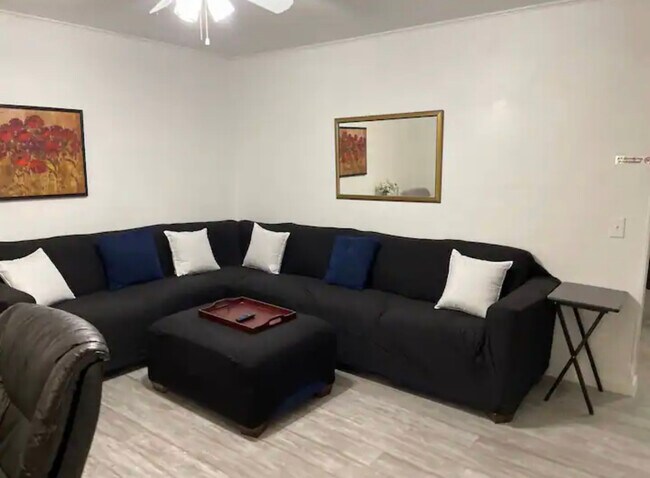 Living room with large sectional and smart TV and desk area - 805 Briarwood Rd