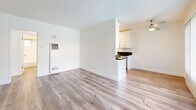 Located at 3729 McLaughlin Ave in the Mar Vista neighborhood of Los Angeles, this one-bedroom, one-bathroom unit offers a thoughtfully laid-out single-floor plan. Warm wood-look flooring flows consistently throughout the space, creating a cohesive and clean aesthetic.

The open living room is bright and airy, featuring large windows with vertical blinds that allow abundant natural light to filter in. The space flows seamlessly into the galley-style kitchen, which is well-appointed with crisp white shaker cabinetry, dark granite-style countertops, and a full suite of stainless steel appliances including a gas range, microwave, refrigerator, and sink with modern fixtures.

The bedroom is a comfortable and well-proportioned retreat, equipped with a ceiling fan, a window with vertical blinds for natural light and privacy, and a reach-in closet for convenient storage. A hallway connects the bedroom to the full bathroom, which includes a bathtub and a small window for ventilation.

The unit's clean white walls, consistent flooring, and updated finishes contribute to a bright, modern ambiance throughout. Its location in the desirable Mar Vista area of Los Angeles offers convenient access to local shops, dining, and amenities.
