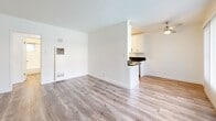 Located at 3729 McLaughlin Ave in the Mar Vista neighborhood of Los Angeles, this one-bedroom, one-bathroom unit offers a thoughtfully laid-out single-floor plan. Warm wood-look flooring flows consistently throughout the space, creating a cohesive and clean aesthetic.

The open living room is bright and airy, featuring large windows with vertical blinds that allow abundant natural light to filter in. The space flows seamlessly into the galley-style kitchen, which is well-appointed with crisp white shaker cabinetry, dark granite-style countertops, and a full suite of stainless steel appliances including a gas range, microwave, refrigerator, and sink with modern fixtures.

The bedroom is a comfortable and well-proportioned retreat, equipped with a ceiling fan, a window with vertical blinds for natural light and privacy, and a reach-in closet for convenient storage. A hallway connects the bedroom to the full bathroom, which includes a bathtub and a small window for ventilation.

The unit's clean white walls, consistent flooring, and updated finishes contribute to a bright, modern ambiance throughout. Its location in the desirable Mar Vista area of Los Angeles offers convenient access to local shops, dining, and amenities.
