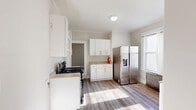 This 600 square foot apartment in Paterson, NJ offers a surprising amount of space with three bedrooms and one bathroom. The interior has been thoughtfully renovated, creating a bright and modern living environment. The kitchen is a standout feature, boasting crisp white cabinetry, stainless steel appliances, and ample counter space. Large windows throughout allow natural light to flood the rooms, enhancing the sense of spaciousness.

The bedrooms, while compact, are well-designed with neutral color schemes and durable laminate flooring. The primary bedroom measures 160 square feet, providing a comfortable retreat. The bathroom has been updated with contemporary fixtures and sleek marble-look tiling, offering both style and functionality.

Throughout the apartment, you'll find a cohesive design aesthetic with light-colored walls, white trim, and consistent flooring. Vintage radiators add character while providing warmth. The layout maximizes the available space, making this apartment an excellent option for those seeking a cozy yet efficient living space in an urban setting.