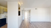 Located at 1540 Chenault St in Dallas, TX, this two-bedroom, two-bathroom residence offers a well-organized single-floor layout designed for comfortable everyday living. The living room serves as the heart of the home, highlighted by vaulted ceilings that lend a sense of openness, a classic fireplace as a focal point, and large windows that invite generous natural light. Wood-style flooring runs throughout the main living areas, adding warmth and continuity to the space.

The galley-style kitchen is efficiently laid out with cabinetry on both sides, a chevron tile backsplash, a double sink, and black appliances including a refrigerator, range, and dishwasher — providing all essential functionality in a clean, organized corridor design.

Both bedrooms are carpeted and feature ceiling fans and dedicated closets. The primary bedroom benefits from a sliding glass door that opens to a private outdoor area, allowing natural light to fill the room. The second bedroom is equally comfortable, with its own closet and easy access to the hallway.

Each bathroom includes a tub/shower combination with tile surround and chrome fixtures, maintaining a clean, neutral aesthetic. Two dedicated closets throughout the unit provide ample storage. The overall palette of soft whites and neutral tones creates a bright, move-in-ready atmosphere throughout the home.