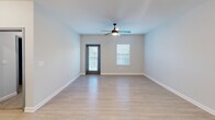 Located at 4582 Ruby Red Drive in Collegedale, Tennessee, this 2-bedroom, 2-bathroom residence offers a thoughtfully designed single-floor layout with contemporary finishes throughout. The open-concept kitchen and living area serves as the heart of the home, with light hardwood-style flooring, ceiling fans, and windows fitted with blinds that invite natural light. The kitchen is equipped with stainless steel appliances — including a refrigerator, range, and over-the-range microwave — complemented by rich dark cabinetry, marble-look quartz countertops, and a classic white subway tile backsplash. The spacious primary bedroom features plush carpeting, a ceiling fan, dual windows, and access to a walk-in closet. The second bedroom also offers hardwood-style flooring and a bright window. Both bathrooms are finished in a clean, neutral palette, each with a tub-shower combination, dark wood vanities, and marble-look countertops. A dedicated laundry room houses a full-size washer and dryer. The overall aesthetic is clean, modern, and move-in ready, with consistent neutral tones and quality finishes that create a cohesive and comfortable living environment.