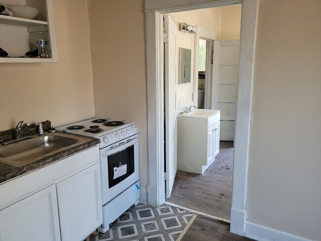 Kitchen livingroom with bedroom in background - 1119 W Augusta Ave