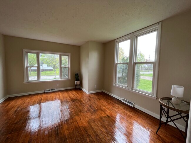 Beautiful and spacious living room with just renovated wood floor. - 800 W Riddle Ave