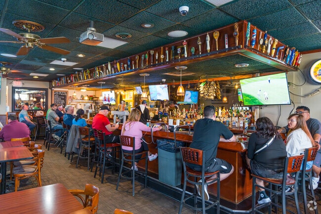 The bar at Tappers Pub has a large tap selection and is famous for its Coney Island Pizza.