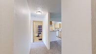 Located at 201 W Betz Rd in Cheney, Washington, this three-bedroom, two-bathroom single-floor residence offers a practical and well-organized layout. The living area features vaulted ceilings and plush carpeting, with a pendant light fixture adding a welcoming touch to the open space. The galley-style kitchen is equipped with light wood cabinetry, ample counter space, a full suite of white appliances including a range, refrigerator, and dishwasher, and tile flooring that flows throughout. A dedicated laundry area accommodates a full-size washer and dryer with overhead shelving for additional storage. Each of the three bedrooms is carpeted and filled with natural light through vertical-blind-covered windows, with baseboard heating providing warmth throughout. The primary bedroom offers a comfortable, well-proportioned space with closet access. Both bathrooms feature tub-shower combinations, wood-toned vanity cabinetry, and hard-surface flooring. A hallway connects the bedrooms and bathrooms, contributing to a well-defined and efficient floor plan. The overall aesthetic is clean and neutral, making this residence in Cheney, WA a straightforward and functional living space.