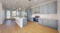 Located at 2301 Westside Blvd SE in Rio Rancho, NM, this well-designed one-bedroom, one-bathroom residence offers a thoughtfully planned single-floor layout with a clean, modern aesthetic. Light-toned hardwood flooring flows consistently throughout the space, complementing the bright white walls and creating a cohesive, airy atmosphere.

The open-concept kitchen is a standout feature, showcasing slate-blue shaker-style cabinetry that extends to the ceiling for ample storage, crisp white countertops, and a full suite of stainless steel appliances including a refrigerator with ice maker, electric range, and microwave. A spacious center island with an undermount sink and pendant lighting above serves as both a prep area and a natural gathering point, seamlessly connecting the kitchen to the living area. Recessed lighting and a ceiling fan add functionality throughout.

The bedroom is bright and comfortable, benefiting from dual windows that bring in generous natural light and offer exterior views. Two closets provide practical storage solutions.

The bathroom is finished with refined details, including grey shaker-style vanity cabinetry, a white countertop, a large mirror, and a striking marble-tiled shower enclosure with sliding glass doors. The overall design is clean and contemporary, making this a well-appointed Rio Rancho residence.