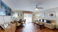 Located at 1141 Mindy Ln in Wooster, Ohio, this well-appointed single-floor, one-bedroom, two-bathroom home offers a thoughtfully designed layout that maximizes comfort and functionality. Rich hardwood-style flooring runs throughout the main living areas, lending warmth and continuity to the space.

A welcoming hallway leads into the open-concept kitchen and living room. The kitchen features warm wood cabinetry, ample counter space, a double-basin sink, and full white appliances including a range, refrigerator, and dishwasher. The adjacent living room is bright and airy, highlighted by a ceiling fan with light fixture and a sliding glass door that floods the room with natural light and provides access to the outdoors.

The bedroom offers a comfortable, carpeted retreat with a window that brings in natural light and includes a dedicated closet for storage. The textured ceiling adds a subtle design element throughout the home. Two bathrooms serve the residence, one of which features accessibility-friendly design elements including grab bars, a wall-mounted sink, and hardwood-style flooring.

Completing this home is a dedicated laundry room equipped with a full-size washer and dryer, along with overhead shelving for additional storage. This home delivers practical, single-level living in a tidy and inviting package.
