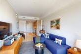 Located at 420 Mendocino Ave in Santa Rosa, CA, this thoughtfully designed one-bedroom, one-bathroom unit offers a modern and efficient layout across a single floor. Light oak hardwood flooring runs throughout, tying together a clean, contemporary aesthetic.

The open-concept living and dining area is bright and welcoming, anchored by a large sliding glass door that leads to a private balcony with open views of the surrounding neighborhood. The kitchen runs along one wall near the entry, featuring flat-front light wood cabinetry, white subway tile backsplash, stainless steel appliances, and a single-basin sink — combining style with practicality.

The bedroom is a comfortable retreat, highlighted by a striking teal accent wall, a large window that draws in generous natural light, and outdoor views. A spacious walk-in closet and an additional closet provide ample storage.

The bathroom is finished with clean, neutral tile flooring, a wall-mounted vanity with light wood cabinetry, and a backlit mirror, creating a sleek and modern feel. In-unit laundry adds everyday convenience.

A hallway connects the spaces cohesively, and the overall design balances warm wood tones with crisp white walls for a fresh, modern ambiance throughout.
