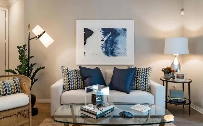 Well-Appointed Living Room with Glass Coffee Table and Soft Lighting - Amerige Pointe