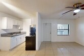 Located at 889 Riverside Dr in Fort Lauderdale, FL, this single-story, one-bedroom, one-bathroom home offers a practical and comfortable layout. Light-toned ceramic tile flooring runs throughout the entire space, lending a clean, cohesive look that is well-suited to the South Florida climate.

The combined dining and living area is bright and open, featuring a ceiling fan with light fixture and a window that invites natural light. The galley-style kitchen is efficiently designed with crisp white cabinetry, granite countertops, a stainless steel sink, and black appliances including a range and refrigerator — maximizing function within a compact footprint.

The bedroom is a generously sized retreat, complete with its own ceiling fan, a window with outdoor views of greenery, and direct access to three closets, providing excellent storage capacity. The bathroom is well-appointed with a full tub-shower combination, accented by classic tile surround in warm neutral tones.

Textured ceilings are consistent throughout the home. The clean white walls create a bright, airy ambiance across every room. With its straightforward layout and practical finishes, this Fort Lauderdale home offers a comfortable and low-maintenance living environment.