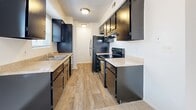This 500 square foot apartment in Mission, KS offers a smart layout with two bedrooms and one bathroom. The space maximizes functionality in its compact design, ideal for those seeking efficiency without compromising comfort. The kitchen stands out with its modern aesthetic, featuring sleek black cabinets, light countertops, and stainless steel appliances. Wood-look flooring in the kitchen and hallways adds warmth and durability.

Both bedrooms are carpeted for comfort, with the primary bedroom boasting a generous 140 square feet. Large windows in the bedrooms allow for ample natural light, creating a bright and airy atmosphere. The bathroom, while not pictured, complements the apartment's overall design.

The apartment's neutral color palette, predominantly in whites and beiges, provides a blank canvas for personalization. Built-in closets in the bedrooms offer valuable storage space. The open layout between rooms enhances the sense of space, making the apartment feel larger than its actual square footage suggests.