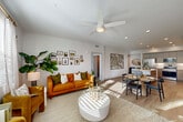 Located at 727 Central Ave in Napa, CA, this well-appointed 2-bedroom, 2-bathroom single-story residence offers a thoughtfully designed open-concept floor plan. Light-toned luxury vinyl plank flooring flows throughout the main living areas, anchoring a bright and cohesive aesthetic defined by crisp white walls and recessed lighting.

The kitchen is a standout feature, showcasing two-tone cabinetry with sleek upper panels and warm wood-grain lower cabinets, a generous white quartz island with bar seating, and a full suite of stainless steel appliances including a gas range, built-in microwave, and French door refrigerator. The kitchen opens seamlessly into the combined dining and living area, which is bathed in natural light from large windows and features ceiling fans throughout.

Both bedrooms are comfortably sized, with the spacious primary bedroom offering ample natural light and access to well-organized walk-in closet space. The two bathrooms are finished with light tile flooring, full tub-shower combinations with white subway tile surrounds, and brushed nickel fixtures. A dedicated laundry area adds everyday convenience. The entrance hallway sets a welcoming tone, accented by clean architectural lines that carry through the entire residence.