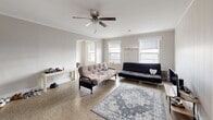 Located at 711 North 16th Street in Milwaukee, Wisconsin, this 2-bedroom, 1-bathroom single-floor unit offers a practical and comfortable layout with classic architectural details throughout. The living room serves as the heart of the space, featuring polished terrazzo floors, crown molding, a ceiling fan, and multiple windows that fill the room with natural light. A charming arched doorway adds a distinctive architectural touch, connecting the living area to the rest of the unit. The galley-style kitchen is efficiently designed with white cabinetry lining both walls, ample counter space, a double-basin sink, and a gas range — providing everything needed for everyday cooking. Both bedrooms are comfortably sized, each featuring windows that invite natural light. The primary bedroom includes vertical shiplap-style wall paneling and a classic cast-iron radiator, adding character to the room. The second bedroom features terrazzo flooring and a mirrored accent. The full bathroom is finished with white subway tile surrounding the tub-shower combination, a penny tile floor, and a vanity with a large mirror. Two hallways connect the rooms, and a dedicated entrance completes the thoughtful, functional floor plan of this Milwaukee residence.