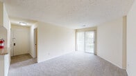 Located at 302 Runaway Bay Cir in Mishawaka, Indiana, this single-floor, 2-bedroom, 1-bathroom residence offers a practical and well-organized layout. The combined living and dining area is finished with plush carpeting and a textured ceiling, and features a sliding glass door fitted with vertical blinds that opens to an outdoor space, allowing natural light to fill the room. The kitchen is efficiently designed with warm wood-toned cabinetry, a stainless steel sink, laminate countertops, wood-look flooring, and white appliances including a range and refrigerator. The primary bedroom is generously sized, carpeted, and features a dedicated walk-in closet with wire shelving for organized storage. The second bedroom is similarly carpeted and bright, with a window offering outdoor views, and includes its own closet. A versatile den includes built-in shelving and a built-in wood desk, ideal for a home office or study area. The full bathroom features tile-look flooring, a combined tub and shower unit, and a wood-toned vanity. A dedicated laundry room with wire shelving, washer hookups, and wood-look flooring adds everyday convenience. Two closets throughout the home provide ample additional storage.