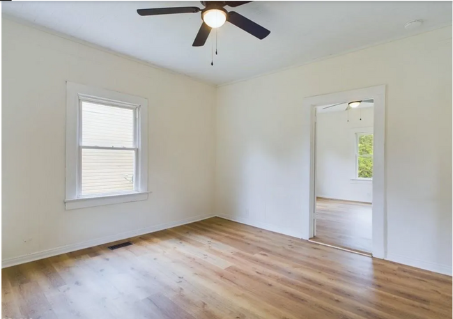 Bedroom 1: A cozy bedroom with natural light streaming through a single window. - 1011 Elm St