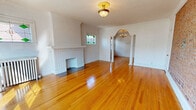 Located at 12467 Cedar Rd in Cleveland Heights, Ohio, this well-appointed one-bedroom, one-bathroom unit showcases classic architectural character throughout its thoughtfully laid-out single floor. Gleaming hardwood floors flow seamlessly through each room, complementing the bright, neutral palette and crown molding that lend a timeless elegance to the space.

The spacious living room is a standout, featuring a white-tiled decorative fireplace, a charming stained glass window, and a vintage brass flush-mount ceiling fixture. A graceful arched opening flanked by decorative columns connects the living room to the dining room, which is illuminated by a classic chandelier. The dining room also boasts a striking exposed brick accent wall and large windows that invite abundant natural light.

The kitchen is efficiently designed with white cabinetry, a bold black marble-style backsplash, and black appliances including a gas range, dishwasher, and refrigerator, all set over warm hardwood flooring. The bedroom offers a comfortable footprint with a double-pane window, a radiator, and two closets — one fitted with a mirrored door.

The bathroom is clean and bright, featuring white tile flooring, a tub/shower combination, a vanity with dark countertop, a glass block window, and a decorative cast-iron radiator. A connecting hallway ties all spaces together cohesively.