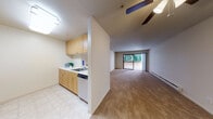 This single-floor residence at 237 Haas Ave in San Leandro, California, offers a practical and well-organized layout designed for comfortable everyday living. The kitchen is positioned along one wall and features light maple cabinetry with ample upper and lower storage, a double-basin sink, white countertops, and a dishwasher. Tile flooring in the kitchen provides a clean transition into the open living area, which is finished with wall-to-wall carpet in a neutral beige tone that extends throughout the main living space and bedroom.

The living area is generously proportioned and draws natural light through a large sliding glass door that opens onto a private balcony with views of surrounding greenery. A ceiling fan overhead adds to the comfort of the space. The bedroom is a well-sized room with carpeting, a mirrored sliding closet, a baseboard heater, and a window framing tree-lined outdoor views, contributing to a calm and quiet atmosphere.

The bathroom features tile flooring, textured walls, a toilet, and a shower and tub combination enclosed by sliding frosted glass doors with grab bars, offering both functionality and accessibility. Overall, the unit presents a clean, understated aesthetic suited to a range of lifestyles.