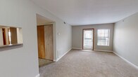 Located at 2413 N Neil St in Champaign, Illinois, this single-floor unit offers a functional and comfortable layout designed for everyday living. The living area is finished with neutral-toned carpet and light gray walls, creating a clean, understated aesthetic. Natural light filters in through blinded windows, and a door provides access to an outdoor area, adding a welcoming sense of openness. An adjoining space features sliding wood-panel closet doors, offering convenient storage.

The kitchen is well-appointed with crisp white shaker-style cabinetry, ample upper and lower storage, a double-basin stainless steel sink, and light wood-look vinyl flooring. White appliances, including a refrigerator and electric range, complete the practical setup.

The bedrooms are carpeted and feature neutral walls with multiple windows that bring in plentiful natural light. Each room includes closet access, providing solid storage solutions. The primary bathroom is finished with wood-look vinyl flooring and includes a full-size soaking tub with a shower combo, a vanity with white cabinetry, a mirror, and warm-toned countertops. A second bathroom also features a clean tub/shower unit. The overall ambiance throughout the unit is bright, tidy, and move-in ready.