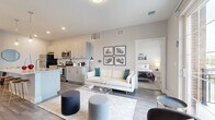 Located at 480 Ackerman Rd in Columbus, Ohio, this well-appointed 2-bedroom, 2-bathroom residence offers a thoughtfully designed single-level layout. The open-concept kitchen and living area serves as the heart of the home, featuring sleek two-tone cabinetry, stainless steel appliances, a subway tile backsplash, and a granite-topped island with bar seating illuminated by stylish pendant lighting. Wood-style flooring flows throughout the main living area, which opens onto a private balcony, filling the space with natural light. The living room provides a comfortable and versatile setting that connects seamlessly to the kitchen. Both bedrooms are carpeted and offer dedicated closets with wire shelving, providing practical storage solutions. The primary bedroom includes an en-suite bathroom and its own closet, while the second bedroom also enjoys convenient access to a full bath. Each bathroom is finished with granite-topped vanities, modern fixtures, and wood-style flooring. Additional conveniences include a dedicated laundry area and a utility room. The overall aesthetic is clean and contemporary, with neutral tones, recessed lighting, and modern finishes throughout, creating a bright and inviting atmosphere.