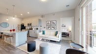 Located at 480 Ackerman Rd in Columbus, Ohio, this well-appointed 2-bedroom, 2-bathroom residence offers a thoughtfully designed single-level layout. The open-concept kitchen and living area serves as the heart of the home, featuring sleek two-tone cabinetry, stainless steel appliances, a subway tile backsplash, and a granite-topped island with bar seating illuminated by stylish pendant lighting. Wood-style flooring flows throughout the main living area, which opens onto a private balcony, filling the space with natural light. The living room provides a comfortable and versatile setting that connects seamlessly to the kitchen. Both bedrooms are carpeted and offer dedicated closets with wire shelving, providing practical storage solutions. The primary bedroom includes an en-suite bathroom and its own closet, while the second bedroom also enjoys convenient access to a full bath. Each bathroom is finished with granite-topped vanities, modern fixtures, and wood-style flooring. Additional conveniences include a dedicated laundry area and a utility room. The overall aesthetic is clean and contemporary, with neutral tones, recessed lighting, and modern finishes throughout, creating a bright and inviting atmosphere.