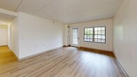 Located at 324 Washington St in Wellesley Hills, MA, this two-bedroom, one-bathroom residence offers a well-organized single-floor layout with a comfortable sense of space throughout. The living room features light wood-look flooring, neutral walls, and a glass-paned door alongside a large multi-pane window that allows natural light to fill the room and provides views of the outdoors. A chandelier-style light fixture adds a decorative touch to the adjacent dining area, which shares the same warm flooring. The kitchen is efficiently designed with cream-toned cabinetry, granite-look countertops, and a full suite of stainless steel appliances including a refrigerator, range, built-in microwave, and dishwasher. Both bedrooms are carpeted and offer a quiet, neutral ambiance. The spacious primary bedroom includes a double-door closet, while an additional walk-in closet with wire shelving provides generous storage. The bathroom is outfitted with wood-look flooring, a walk-in shower with safety grab bars, and a clean, accessible layout. Overall, the residence presents a practical and well-appointed living environment in a desirable Wellesley Hills location.