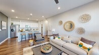 Located at 3561 Sunshine Ridge Dr in Grand Rapids, Michigan, this single-floor home offers a thoughtfully designed open-concept layout that seamlessly connects the living, dining, and kitchen areas. The living room is bright and welcoming, featuring hardwood-style flooring, a ceiling fan, recessed lighting, and a large window that invites natural light and outdoor views.

The kitchen is a standout feature, outfitted with crisp white cabinetry, granite countertops, a classic subway tile backsplash, and a full suite of stainless steel appliances. A dedicated walk-in pantry provides generous storage, adding both functionality and convenience to the space.

The home includes two well-appointed bedrooms, each finished with plush carpeting and ample natural light from large windows. One bedroom features a spacious closet, while the layout accommodates comfortable furnishings throughout. Two bathrooms serve the home: one with a glass-enclosed walk-in shower and granite vanity, and a second full bathroom with a tub-shower combination and matching granite countertops, both finished with rich hardwood-style flooring.

A dedicated laundry area with a full-size washer and dryer completes the home's practical offerings. Neutral tones and consistent finishes throughout create a cohesive, modern aesthetic that is both functional and inviting.