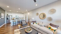 Located at 3561 Sunshine Ridge Dr in Grand Rapids, Michigan, this single-floor home offers a thoughtfully designed open-concept layout that seamlessly connects the living, dining, and kitchen areas. The living room is bright and welcoming, featuring hardwood-style flooring, a ceiling fan, recessed lighting, and a large window that invites natural light and outdoor views.

The kitchen is a standout feature, outfitted with crisp white cabinetry, granite countertops, a classic subway tile backsplash, and a full suite of stainless steel appliances. A dedicated walk-in pantry provides generous storage, adding both functionality and convenience to the space.

The home includes two well-appointed bedrooms, each finished with plush carpeting and ample natural light from large windows. One bedroom features a spacious closet, while the layout accommodates comfortable furnishings throughout. Two bathrooms serve the home: one with a glass-enclosed walk-in shower and granite vanity, and a second full bathroom with a tub-shower combination and matching granite countertops, both finished with rich hardwood-style flooring.

A dedicated laundry area with a full-size washer and dryer completes the home's practical offerings. Neutral tones and consistent finishes throughout create a cohesive, modern aesthetic that is both functional and inviting.