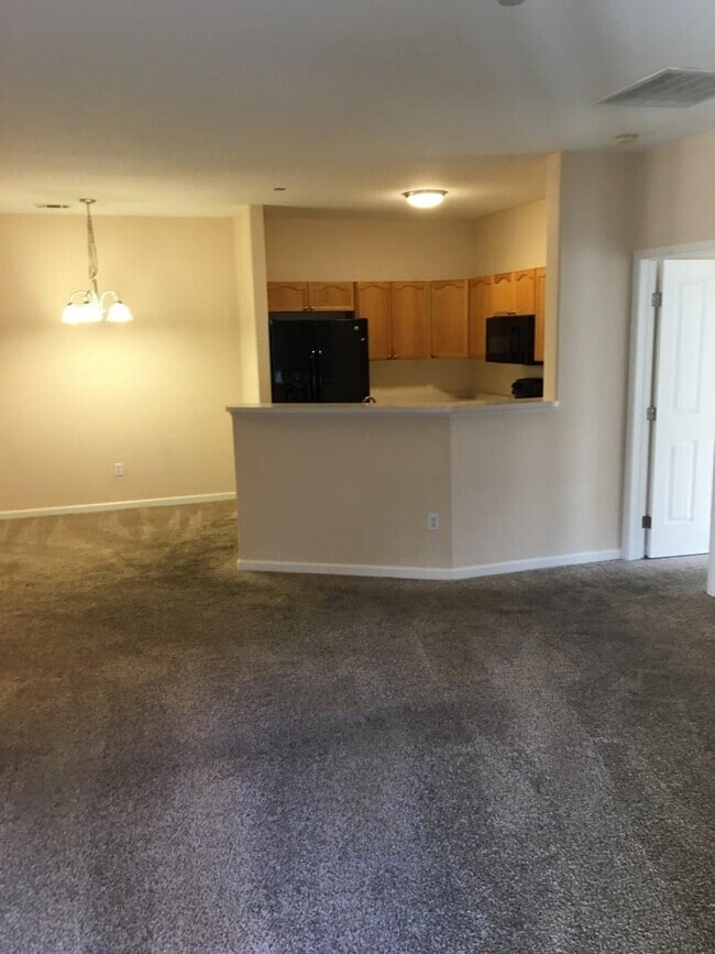 view of kitchen from living room, new carpet, paint, light fixtures - 7375 S Alkire St