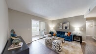 This 1-bedroom, 2-bathroom home delivers a smart and functional layout across a single floor. The open-concept living, dining, and kitchen area forms the heart of the space, with wood-style flooring flowing throughout the main areas. The living room is bright and welcoming, featuring a sliding glass door that floods the room with natural light and provides access to an outdoor area. A dedicated dining nook offers a cozy setting for meals, while the well-equipped kitchen features granite-style countertops, white cabinetry, stainless steel appliances including a gas range, and a convenient breakfast bar that opens to the living space. An in-unit laundry area is tucked just off the kitchen, adding everyday practicality. The generously sized primary bedroom is a standout feature, offering plush carpeting, multiple windows with outdoor views, and ample space for a large furniture arrangement. Two closets provide excellent storage throughout the home. The two bathrooms are clean and functional, each featuring wood-style flooring and well-appointed vanities with granite-style countertops. Neutral gray tones throughout the home create a calm, cohesive aesthetic that suits a variety of styles.