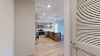 Located at 1015 Gant Hill Drive in Brentwood, Tennessee, this single-floor, three-bedroom, two-bathroom home offers a well-designed layout with a clean, contemporary aesthetic throughout. The kitchen is a standout feature, showcasing gray shaker-style cabinetry, a marble-look tile backsplash, stainless steel appliances including a French door refrigerator, electric range, and built-in microwave, along with a peninsula with pendant lighting and light hardwood-style flooring that extends into the open living area. The bathrooms are finished with large-format white tile flooring, a navy blue vanity with a white countertop in one bath, and a full tub-shower combination with built-in shelving in each. The three bedrooms feature neutral carpet, soft natural light from multiple windows with views of the surrounding area, and generous closet space — including a walk-in closet with wire shelving. Hallways connect the rooms efficiently, and the home's neutral color palette of whites and warm beiges creates a bright, inviting atmosphere throughout. Two dedicated closets provide additional storage. This well-appointed home combines modern finishes with functional design in the heart of Brentwood.