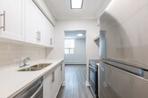 This newly renovated apartment offers 920 square feet of contemporary living space on a single floor. The open concept design seamlessly integrates the living room, dining area, and kitchen, creating a spacious and airy atmosphere. The kitchen boasts modern appliances, white cabinetry, and a sleek design that maximizes functionality.

The apartment features two bedrooms, including a primary bedroom of 170 square feet, providing ample space for relaxation. Both bathrooms have been updated with modern fixtures and finishes, including a vanity with storage in the main bathroom.

Throughout the apartment, large windows allow natural light to flood the rooms, enhancing the bright and welcoming ambiance. The floors are finished with high-quality, durable laminate that mimics the warmth of hardwood, adding to the overall modern aesthetic.

The neutral color palette of whites and light grays creates a clean, fresh backdrop that can easily accommodate various decor styles. Crown molding and baseboards add a touch of elegance to the space.

Located at 3189 King St E in Kitchener, Ontario, this apartment combines contemporary design with practical living, making it an ideal home for those seeking a modern, low-maintenance lifestyle in a convenient urban setting.