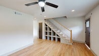 Located at 3170 Alston Dr. in Decatur, GA, this two-story home offers a thoughtfully designed layout spread evenly across two floors. Light hardwood flooring runs throughout, complementing the clean, neutral palette that gives the space a bright and contemporary feel. The kitchen is a standout feature, equipped with a stainless steel gas range, white quartz countertops, warm natural wood cabinetry, open floating shelves, a white subway tile backsplash, and a black matte faucet — all tied together with light hardwood floors and a window that brings in natural light. The three bathrooms are finished with dark hexagonal floor tiles, light wood vanities with white countertops, black matte fixtures, and framed mirrors, lending a modern yet inviting aesthetic. One bathroom includes a tiled shower, while another features a full tub-shower combination with a white tile surround and decorative accent tile. Both bedrooms are generously proportioned, each featuring ceiling fans, hardwood floors, natural light from windows with views of surrounding greenery, and dark-painted paneled doors. The spacious primary bedroom includes a walk-in closet. The home also includes a hallway, staircase, and a small outdoor area visible from the exterior.