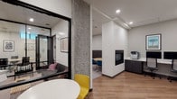 Located at 4717 Brooklyn Avenue NE in Seattle's vibrant University District, this modern coworking space is thoughtfully designed to support a range of professional needs across a single floor. The interior features a clean, contemporary aesthetic with white walls, warm wood-look flooring, exposed concrete columns, and recessed lighting throughout.

The open coworking area offers generous bench-style seating along a textured upholstered wall, complemented by an array of light wood workstations with built-in cable management and colorful accent chairs in teal, yellow, and rust tones. Framed artwork adds character throughout the space.

Private meeting rooms enclosed in sleek black-framed glass partitions provide focused environments for small groups or confidential discussions, with conference tables and ergonomic seating. A dedicated lounge pod with a sofa offers a more casual retreat for individual work or informal meetings.

A business center station features dual desktop computers, a printer/copier, and built-in cabinetry for storage. A compact fireplace anchors one corner of the main collaborative area, adding warmth and a welcoming atmosphere. The space also includes a small informal seating nook with a round table and accent chairs, ideal for one-on-one conversations. Overall, the layout balances open collaboration with private productivity zones seamlessly.