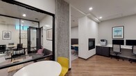 Located at 4717 Brooklyn Avenue NE in Seattle's vibrant University District, this modern coworking space is thoughtfully designed to support a range of professional needs across a single floor. The interior features a clean, contemporary aesthetic with white walls, warm wood-look flooring, exposed concrete columns, and recessed lighting throughout.

The open coworking area offers generous bench-style seating along a textured upholstered wall, complemented by an array of light wood workstations with built-in cable management and colorful accent chairs in teal, yellow, and rust tones. Framed artwork adds character throughout the space.

Private meeting rooms enclosed in sleek black-framed glass partitions provide focused environments for small groups or confidential discussions, with conference tables and ergonomic seating. A dedicated lounge pod with a sofa offers a more casual retreat for individual work or informal meetings.

A business center station features dual desktop computers, a printer/copier, and built-in cabinetry for storage. A compact fireplace anchors one corner of the main collaborative area, adding warmth and a welcoming atmosphere. The space also includes a small informal seating nook with a round table and accent chairs, ideal for one-on-one conversations. Overall, the layout balances open collaboration with private productivity zones seamlessly.