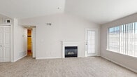 Located at 7550 S Blackhawk St in Englewood, CO, this well-designed one-bedroom, one-bathroom home offers a smart and functional layout across a single floor. The open-concept living room and kitchen area serves as the heart of the home, where a vaulted ceiling adds a sense of spaciousness and airiness. A classic white-mantled fireplace anchors the living area, complemented by plush carpeting and a sliding glass door that invites natural light and outdoor access. Large windows throughout the space further enhance the bright, airy atmosphere.

The kitchen is outfitted with crisp white cabinetry, light hardwood-style flooring, a deep single-basin sink, and a full suite of stainless steel appliances including a refrigerator, electric range, and built-in microwave. A skylight overhead fills the kitchen with additional natural light.

The bedroom is a comfortable retreat featuring soft carpeting, a ceiling fan with light fixture, and a generous window. Two closets provide excellent storage options throughout the home. The bathroom features a full soaking tub with shower, white tile surround accented by a bold teal border stripe, and clean, classic finishes. A hallway connects the spaces with ease, completing this cohesive and practical home.